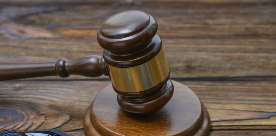 hammer of the judge. two collided inverted cars on a wooden background